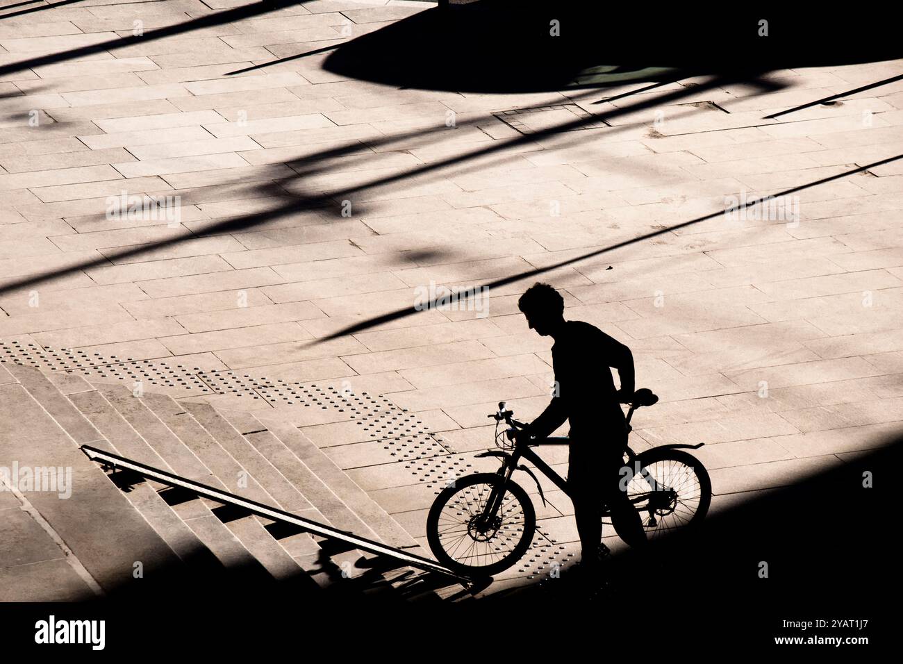 Cyclist carrying bicycle on steps hi-res stock photography and images ...