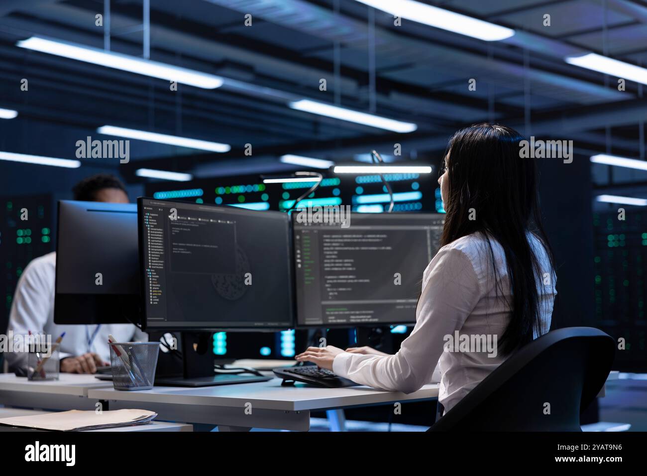 Software developers in data center running system diagnostic tests on PC to fix problems. IT staff members deploying and error checking utilities on computers to repair network issues performance Stock Photo