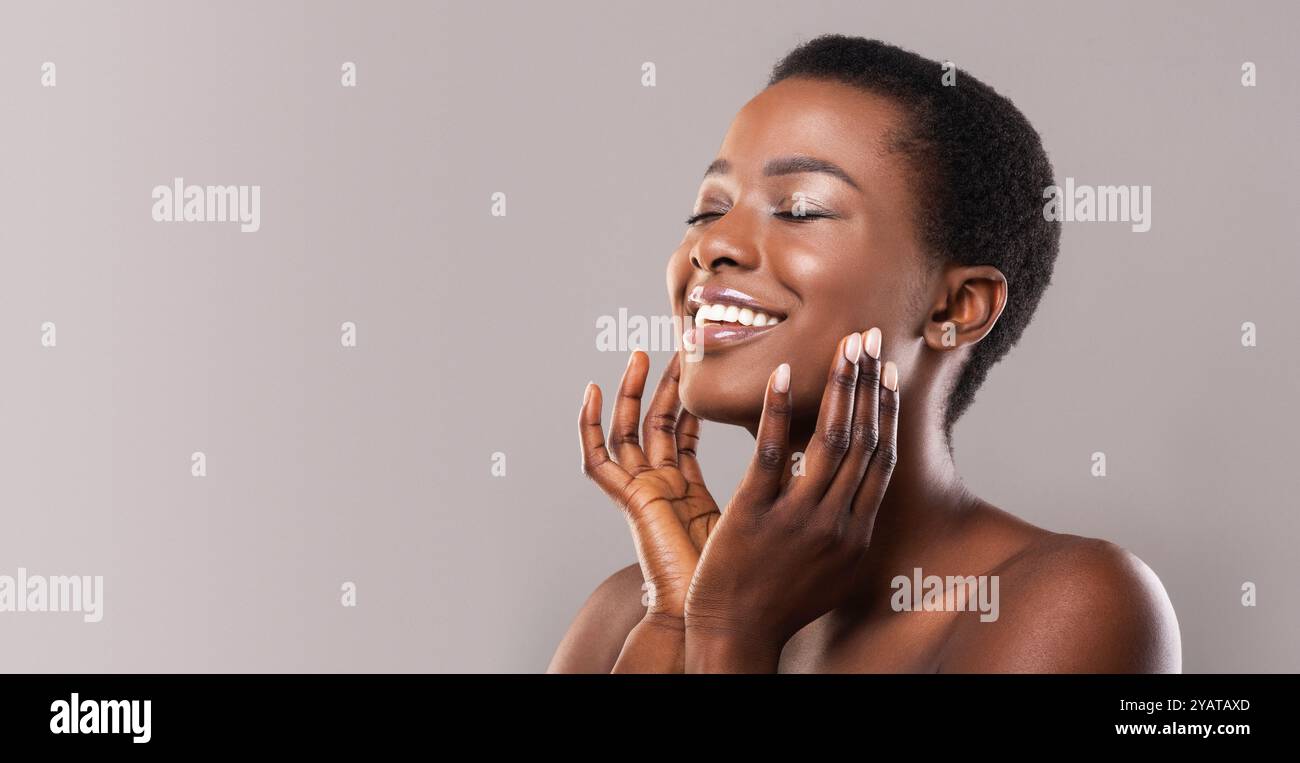 Happy afro woman touching soft smooth skin on her face Stock Photo - Alamy