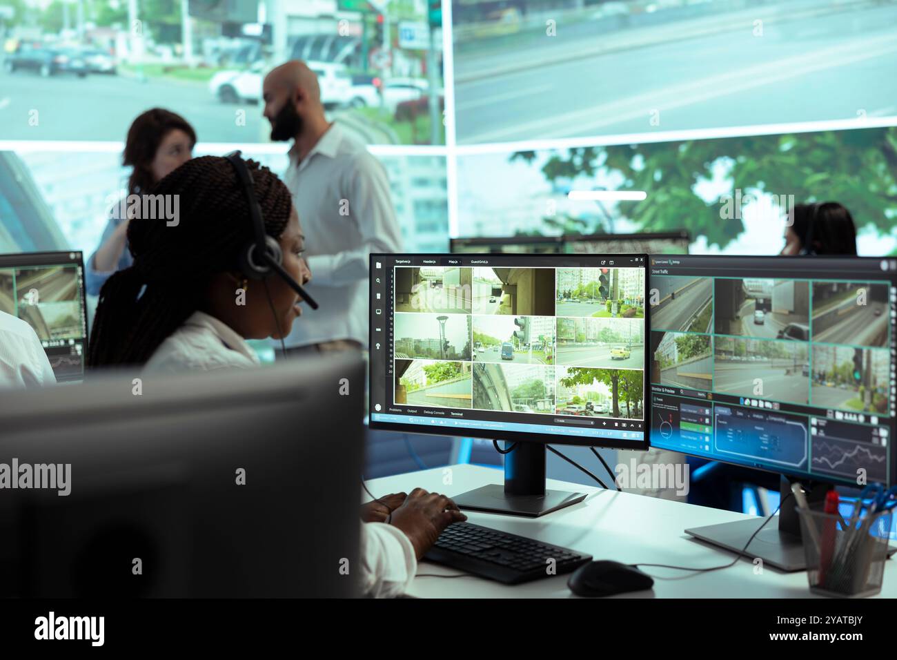 African american dispatch operator uses satellite sensors system to ...