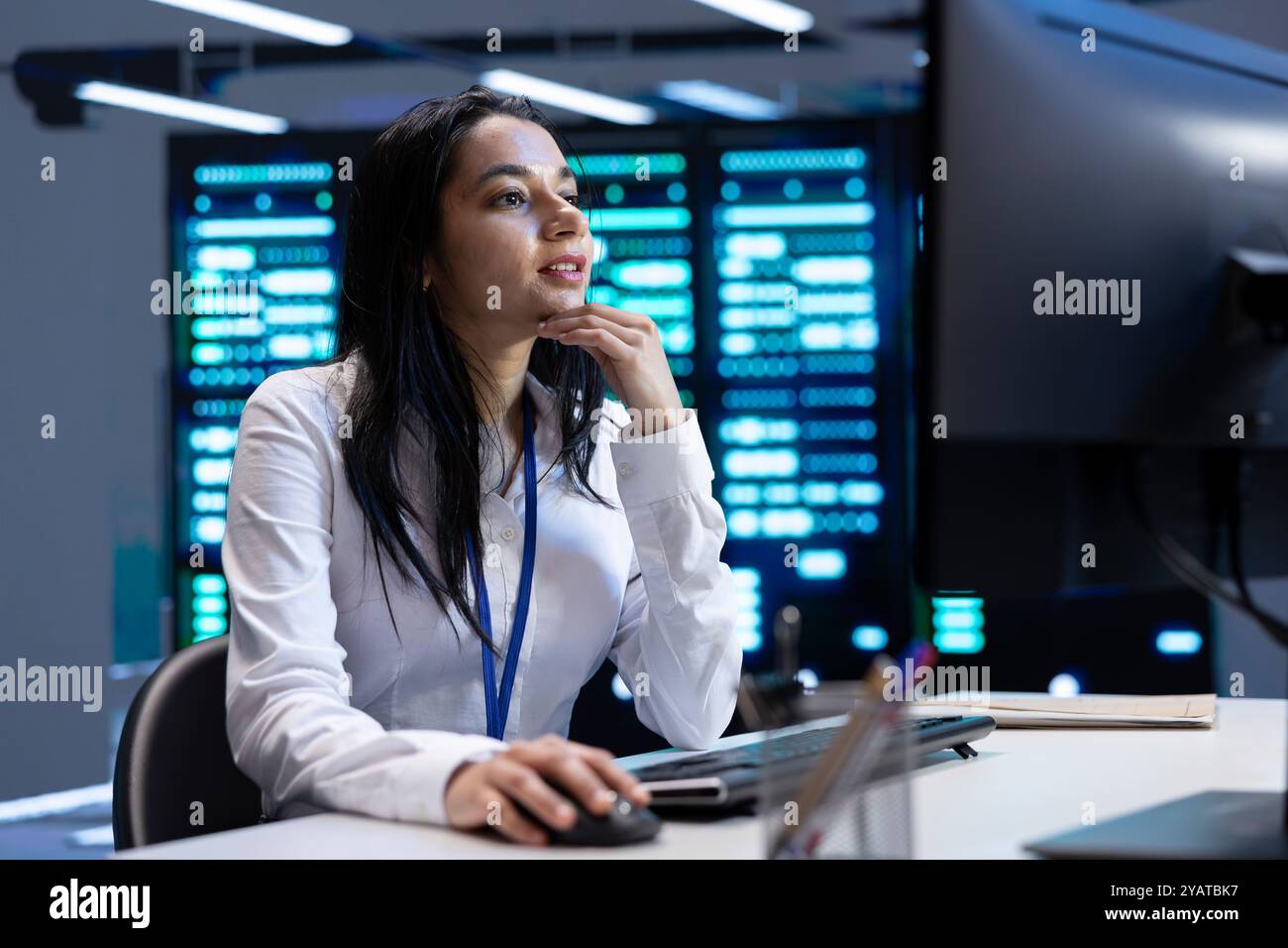 Admin in data center using computer to check for server performance issues arising due to high CPU usage. Server room employee at PC fixing insufficient memory errors slowing down hardware Stock Photo