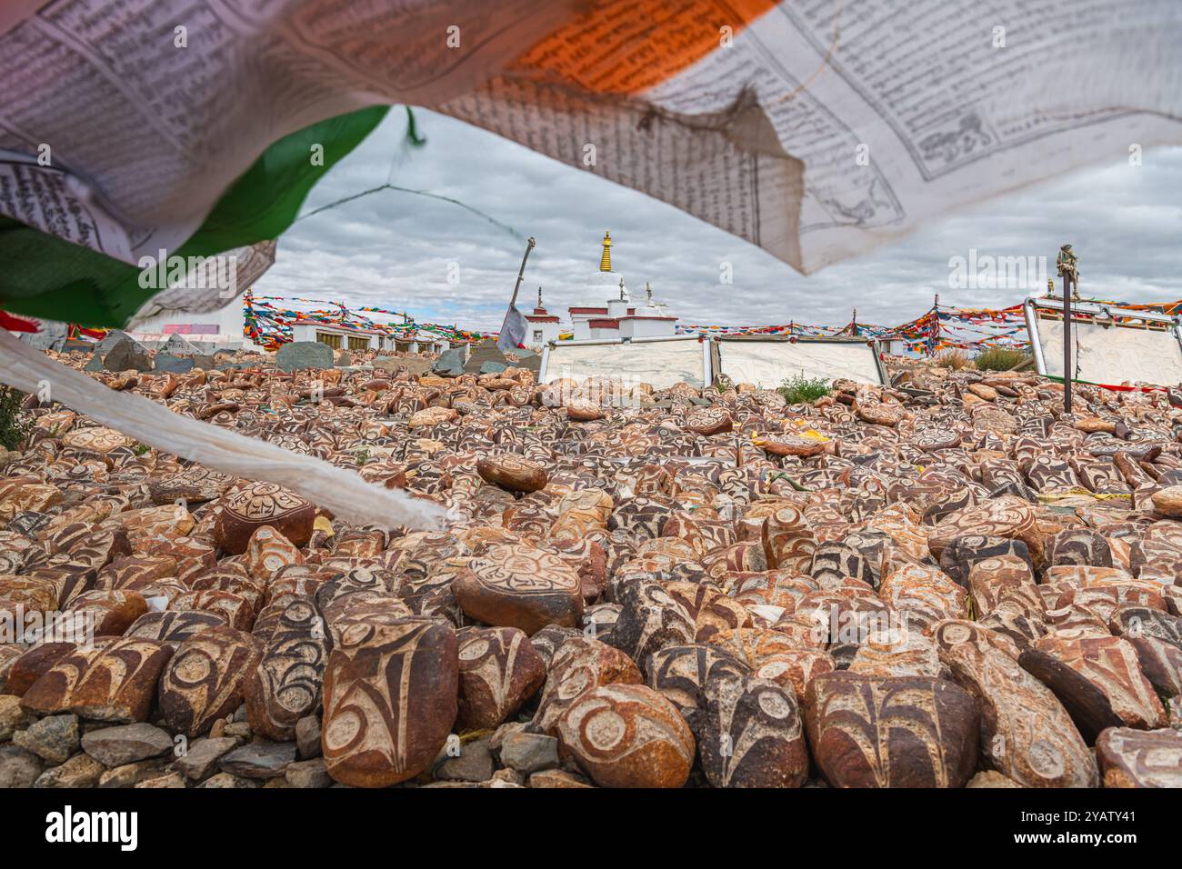 SHIGATSE, TIBET, CHINA - AUGUST, 2 2022: Pebbles from sacred Lake Manasarovar with hieroglyphs and main Buddhist mantra Om Mani Padme Hum , which can Stock Photo