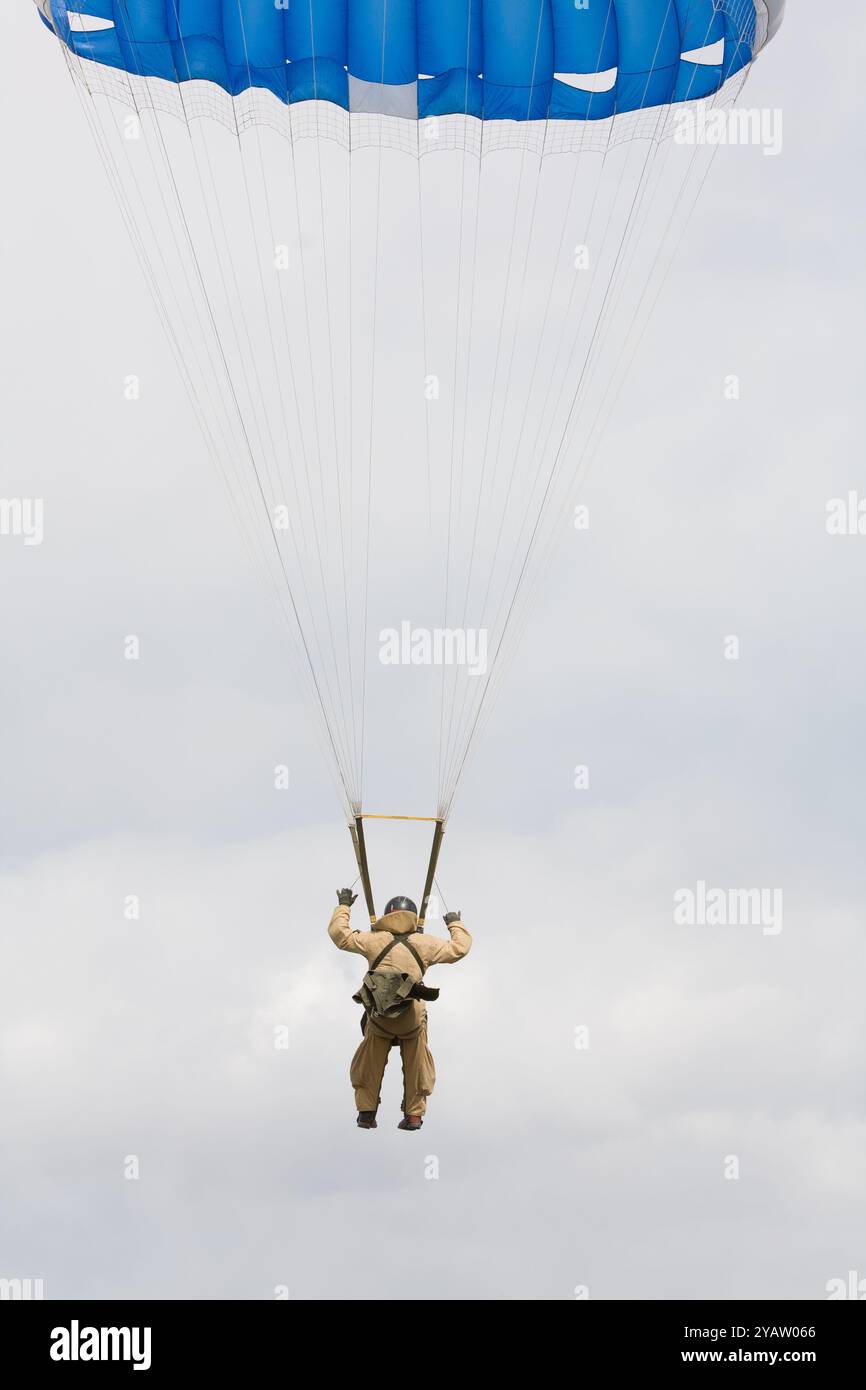 A Forest Servce smokejumper descends towards the landing zone on a practice jump, Missoula, MT. Round canopy is less maneuverable than square Ram-Air. Stock Photo