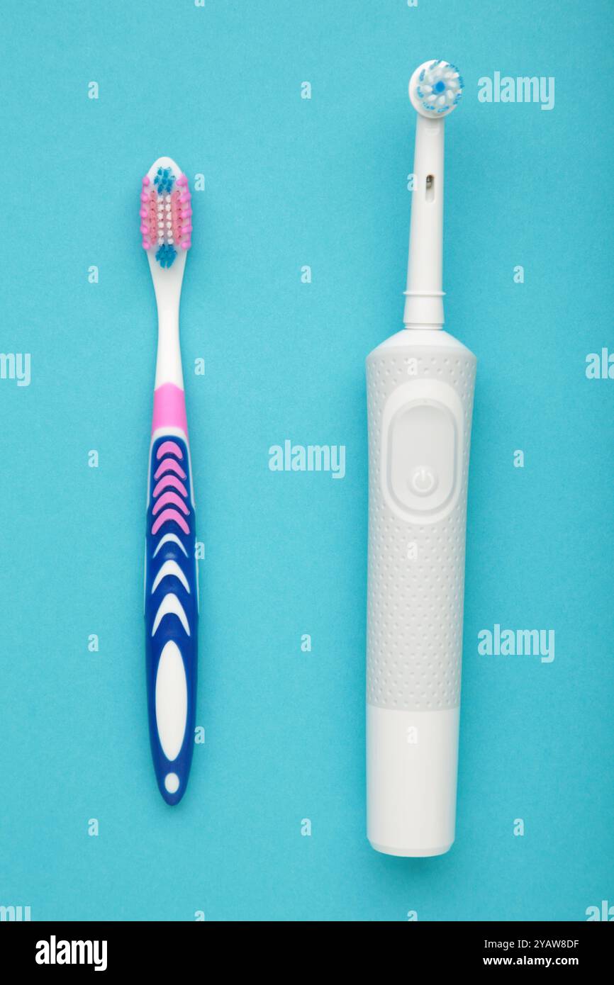 Electric and manual toothbrush on blue background. Top view Stock Photo ...