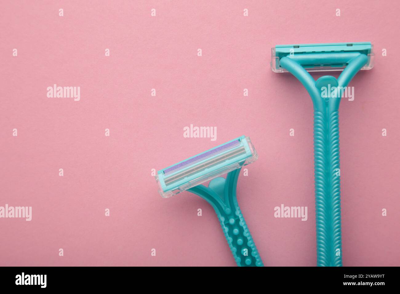 Blue razors for hair removal on pink background. Top view Stock Photo ...