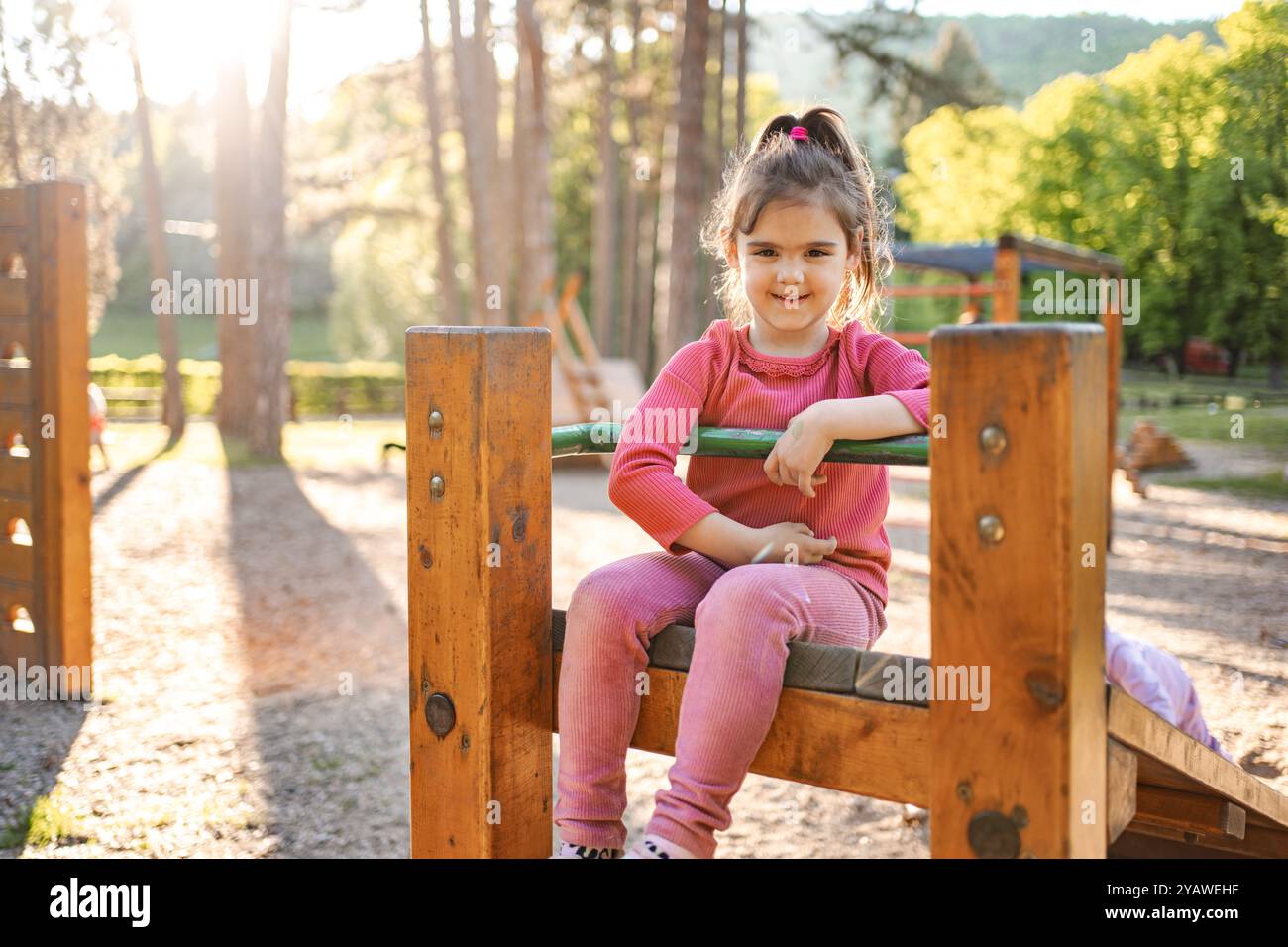 Active cute little girl on the playground Stock Photo - Alamy