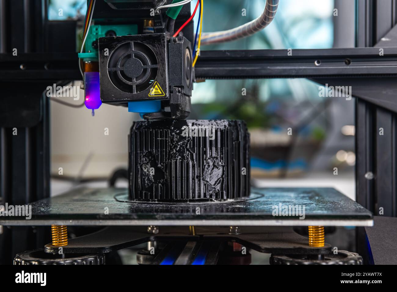 A 3D printer prints a black model. Technology at home Stock Photo