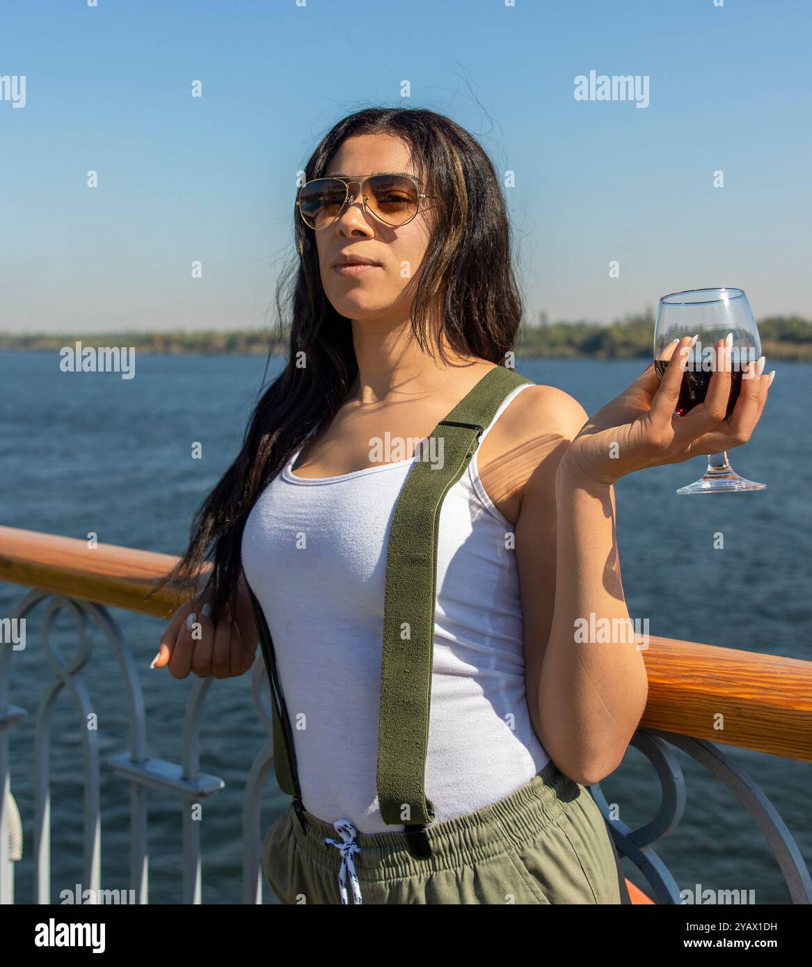 Woman embarking on an epic journey down the Nile and reconnecting with herself. Discovering the history of the pharaohs, enjoying the natural beauty a Stock Photo