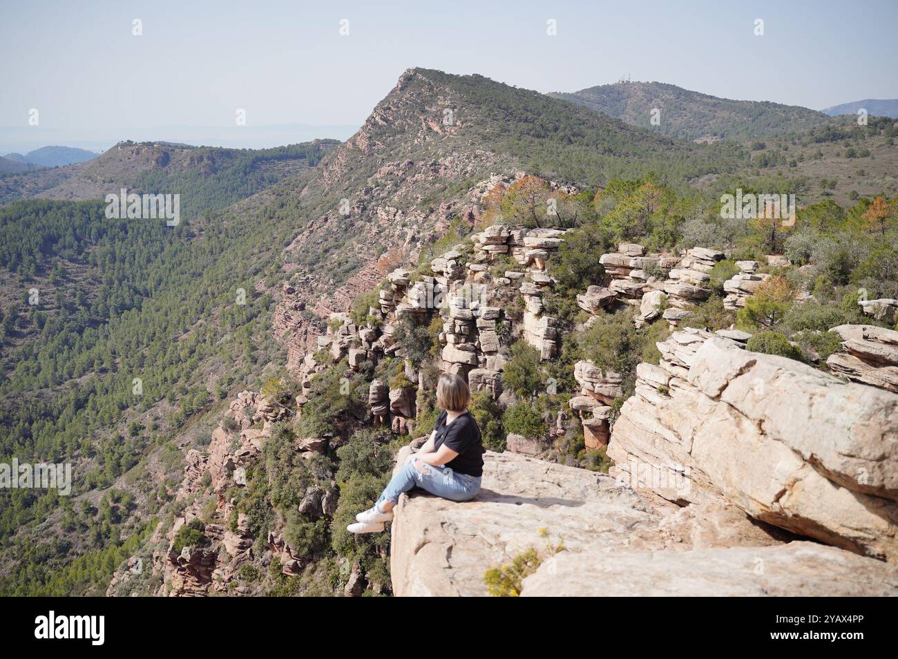 Girl sitting on edge cliff hi-res stock photography and images - Alamy