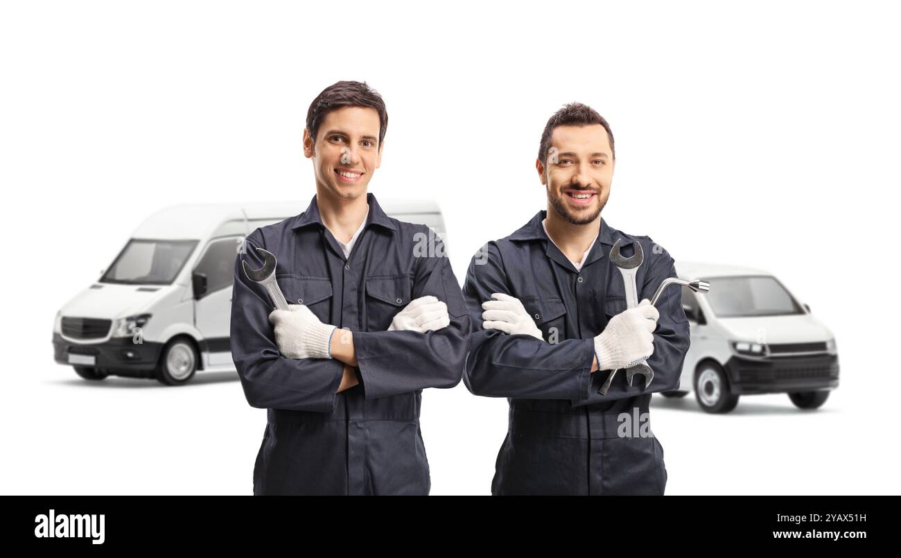 Two male workers with vans holding tools isolated on white background Stock Photo