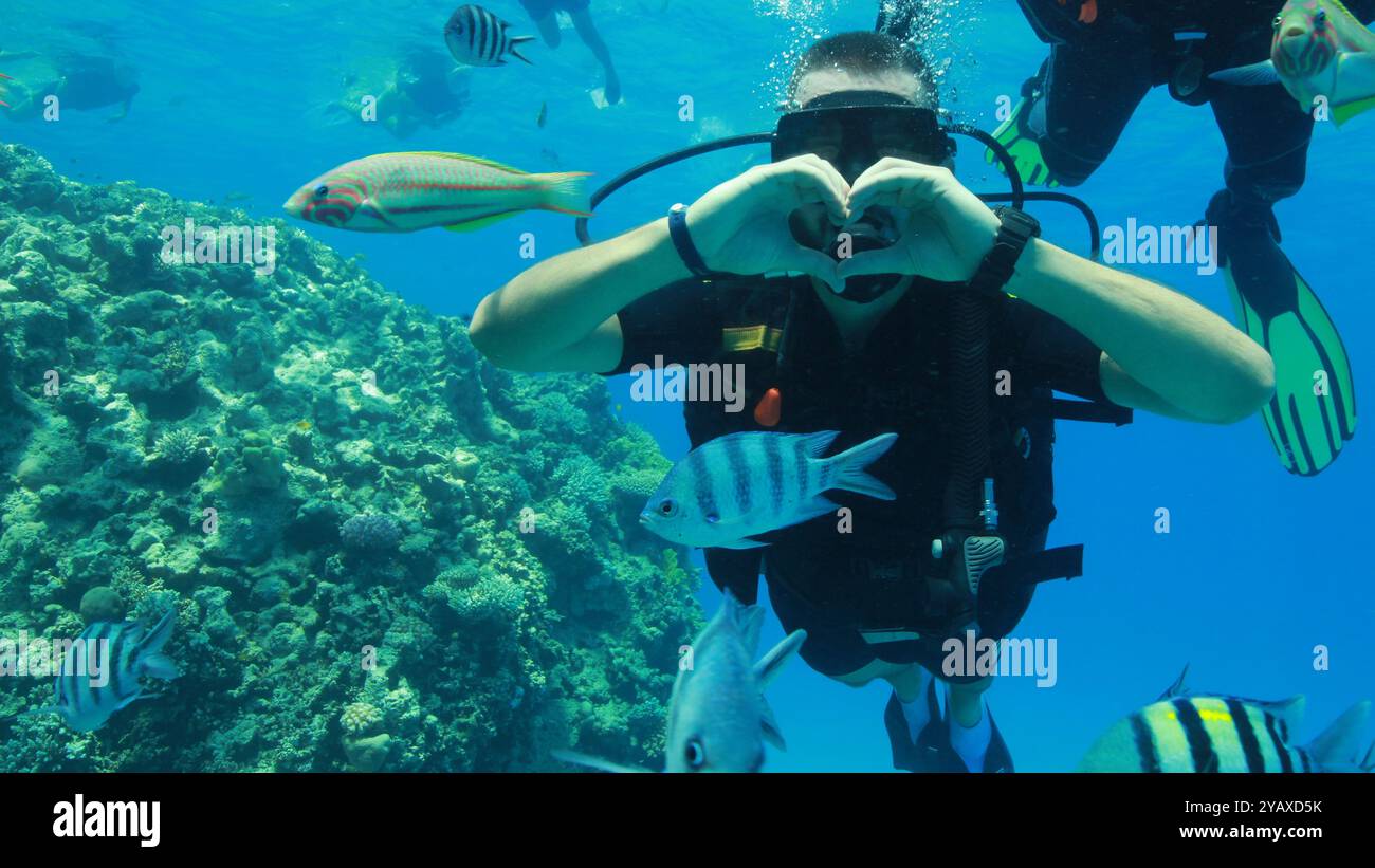 Scuba diver making heart with his hands Stock Photo
