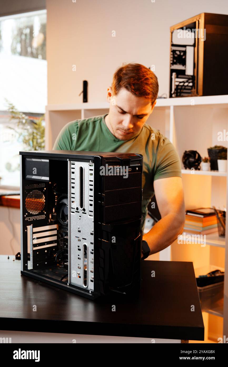 Man assembles a computer system unit at home Stock Photo