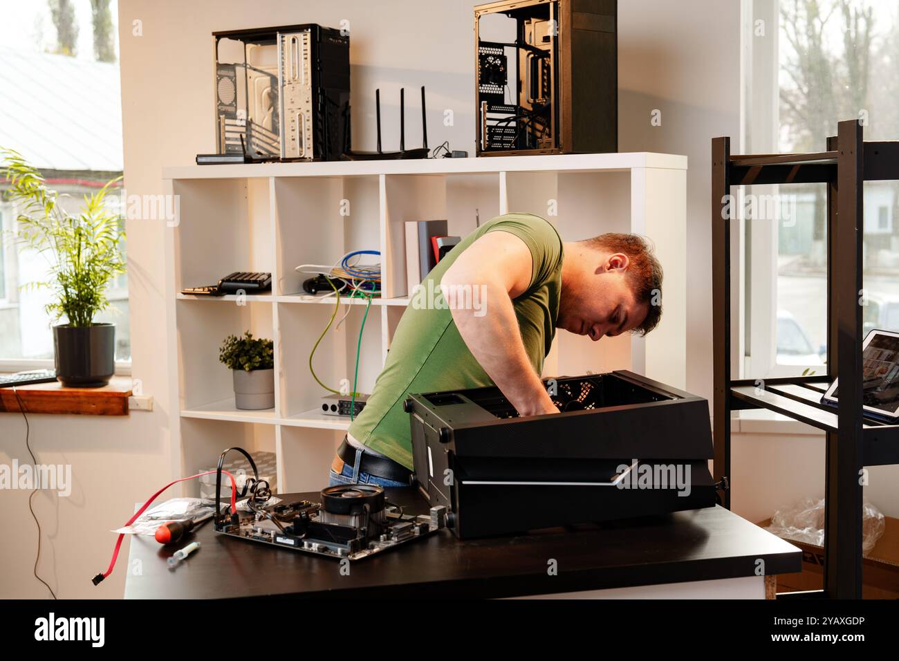 Man assembles a computer system unit at home Stock Photo