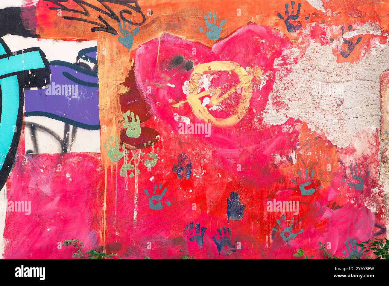 Colorful wall, view of a section of a weathered multicolored mural on a wall in Crete, Greece. Stock Photo