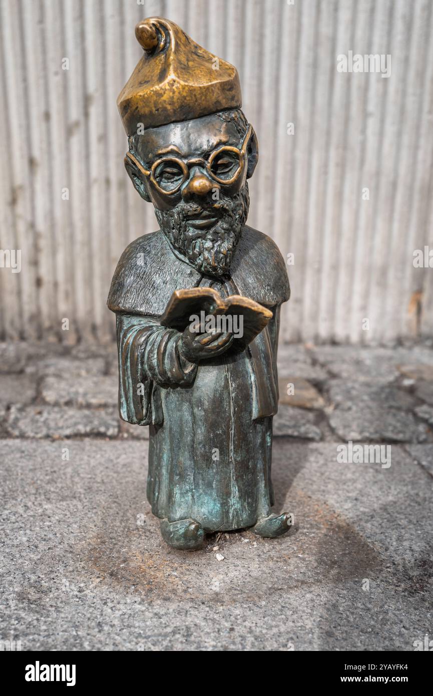 Bronze gnome statues stand on a cobblestone street, showcasing ...