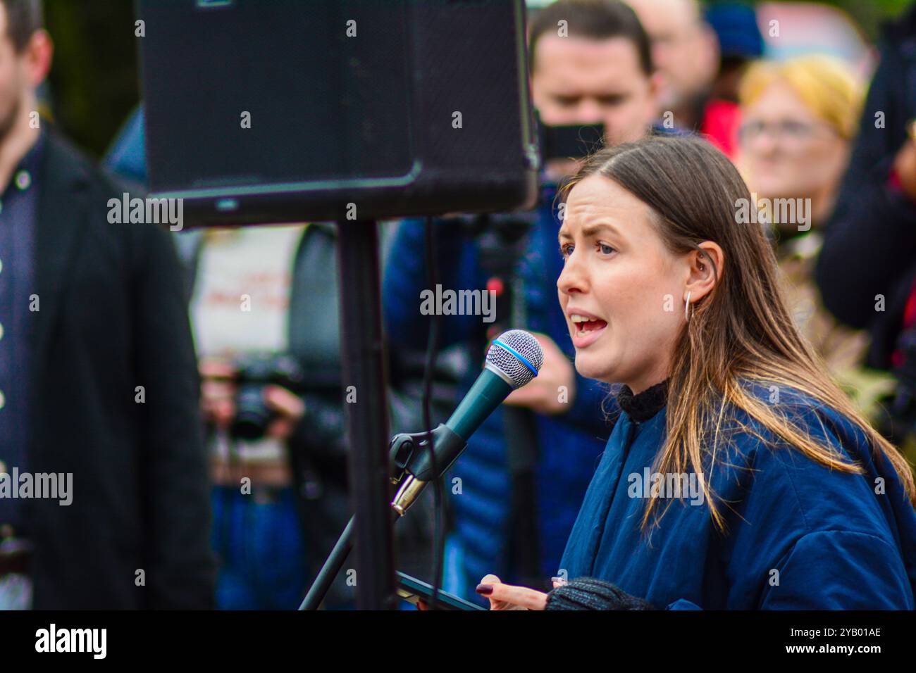 Belfast, United Kingdom 16/10/2024 Fiona Ferguson from People Before Profit speaks to crowd of protesters gathered at Queens University. Protest at Queens University Belfast organised by ROSA NI to protest the rise in femicide cases in Northern Ireland Belfast Northern Ireland credit:HeadlineX/Alamy Live News Stock Photo