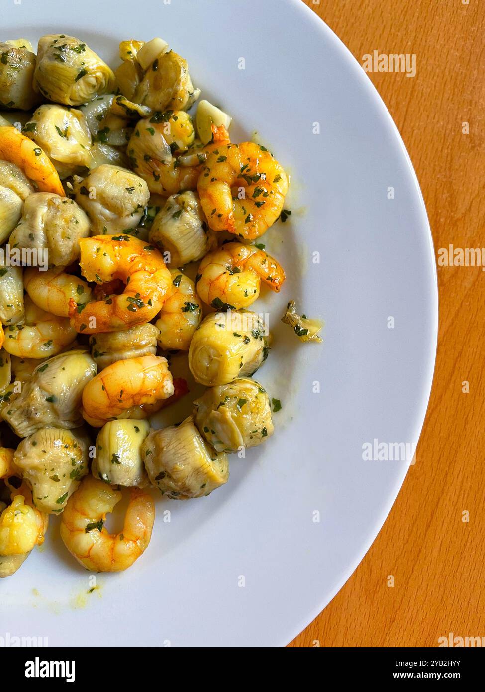 Prawns with artichokes, garlic, coriander and olive oil. - Smartphone Captured Stock Image
