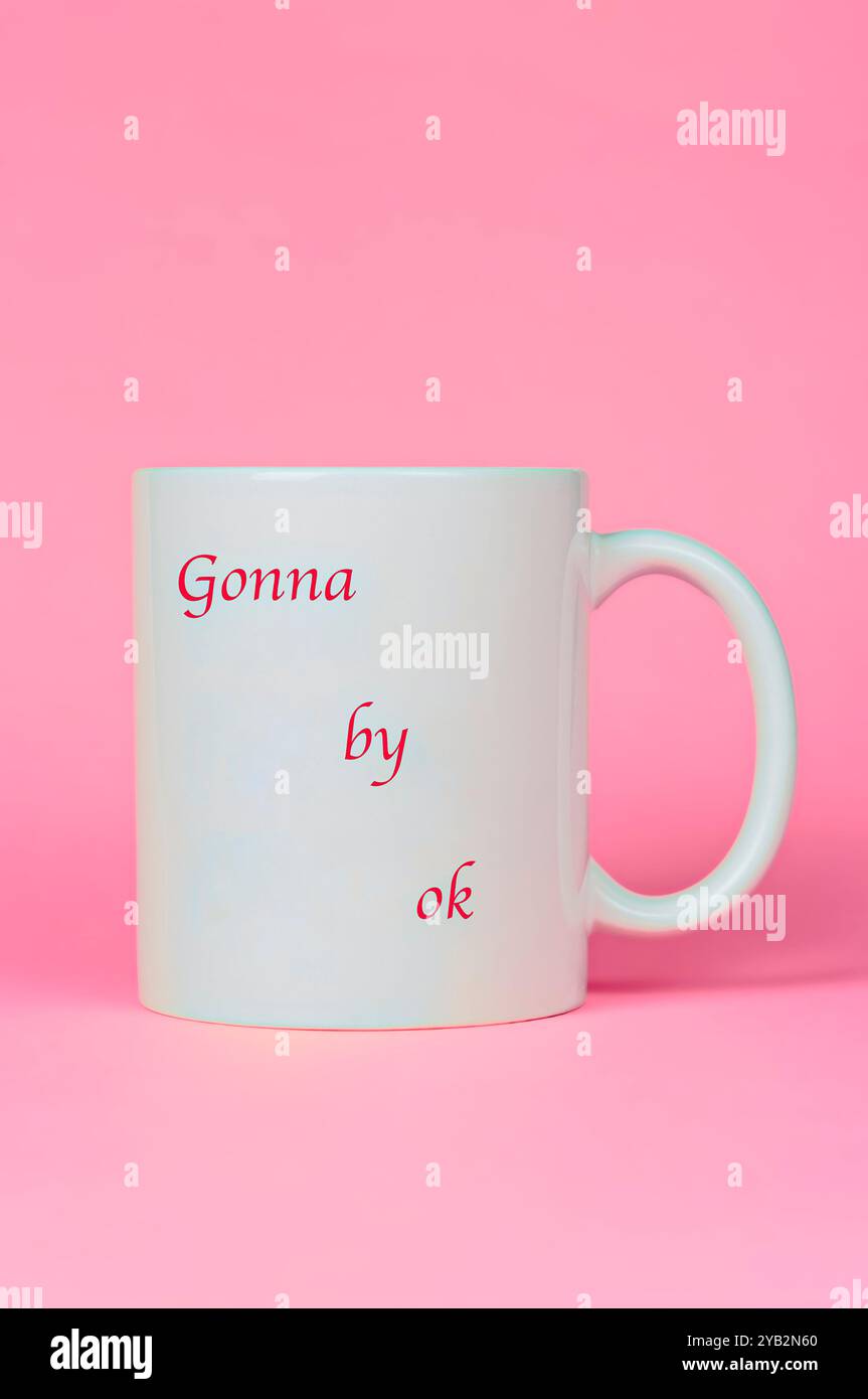 A mug with the phrase written on it: gonna be ok. Stock Photo