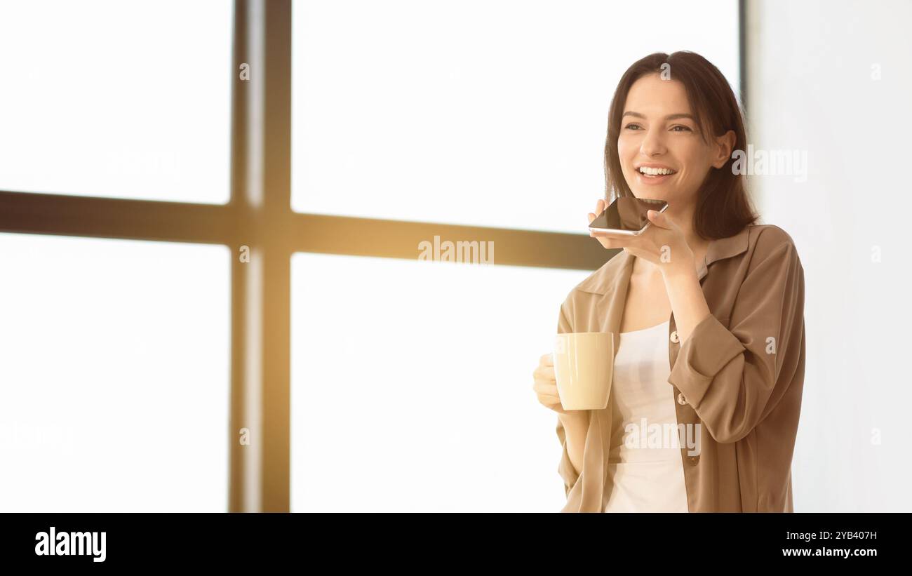 Young woman using mobile voice recognition function Stock Photo