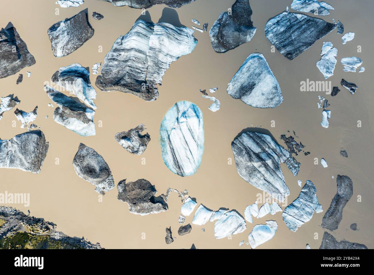 Glacier tongue of the Öræfajökull, small icebergs melting in the lagoon, muddy water, top down view, Iceland Stock Photo