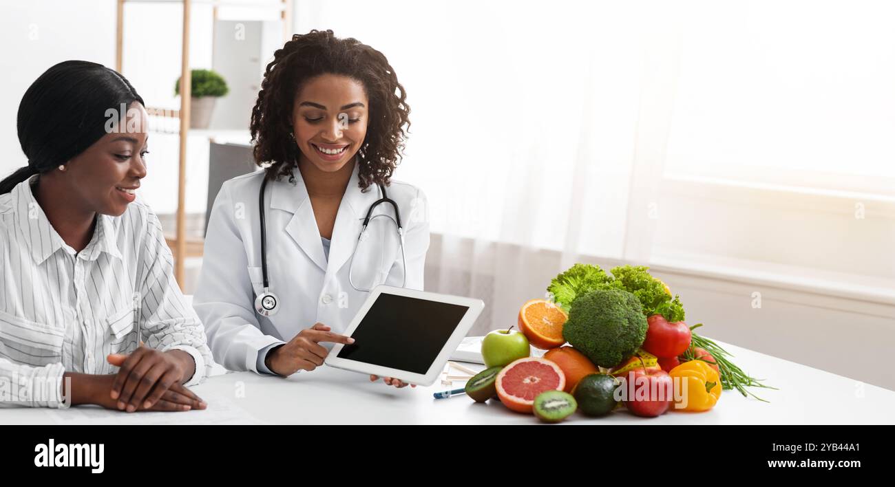 Dietologist using digital tablet in office, making patient's anamnesis Stock Photo