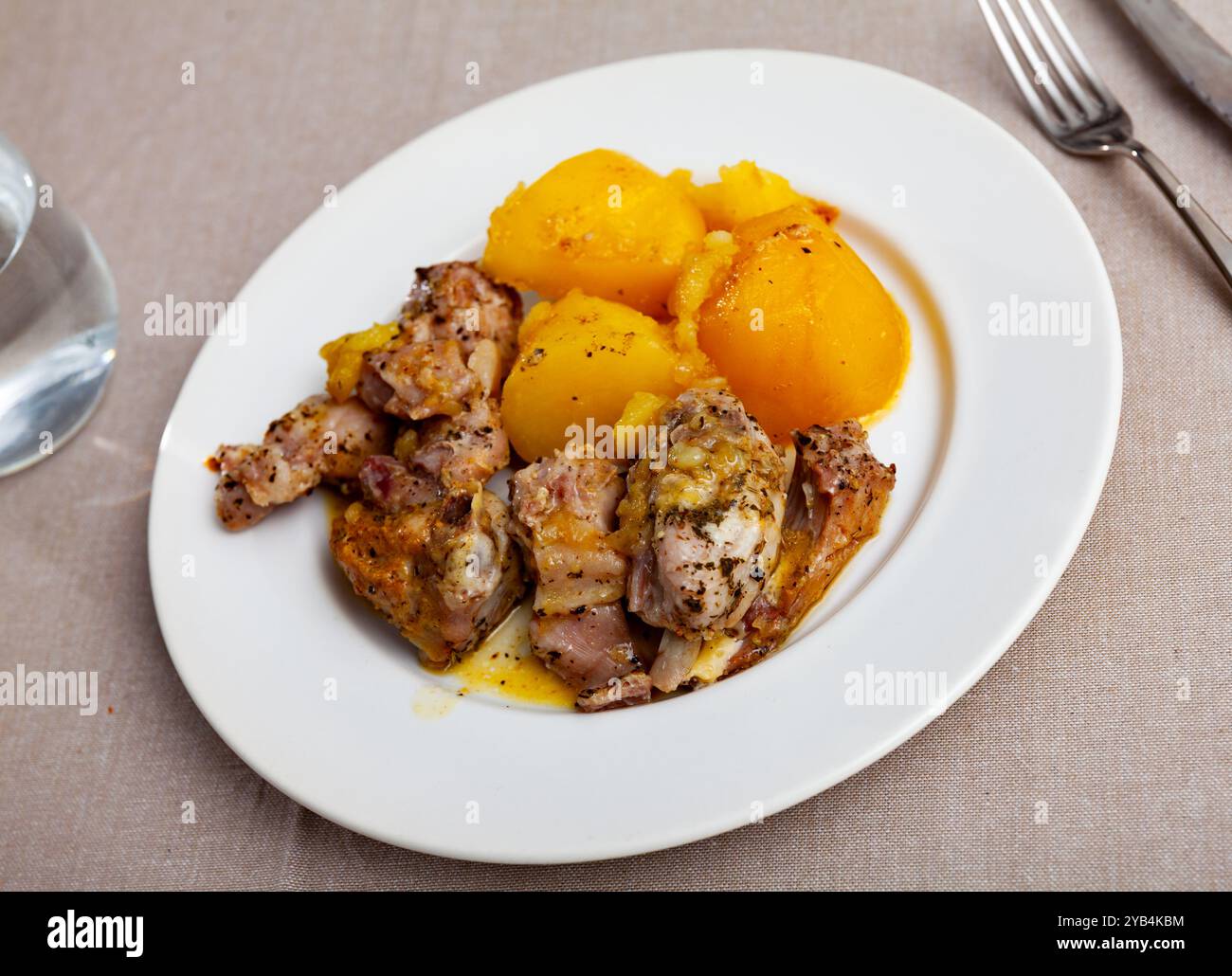Braised rabbit served with potato garnish Stock Photo