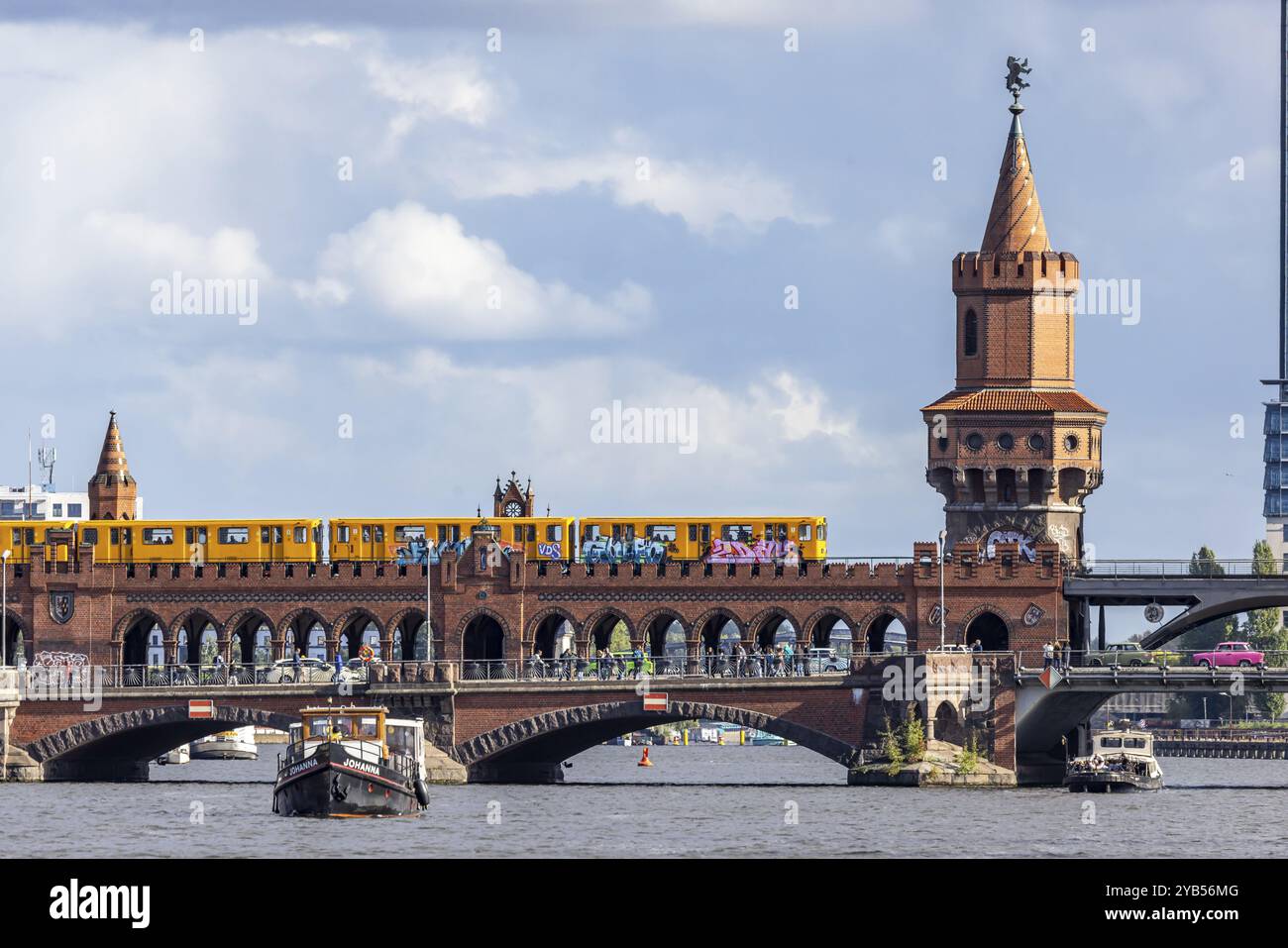 Oberbaum Bridge with underground and pink Trabbi, connection between the districts of Kreuzberg and Friedrichshain across the Spree, part of the inner Stock Photo