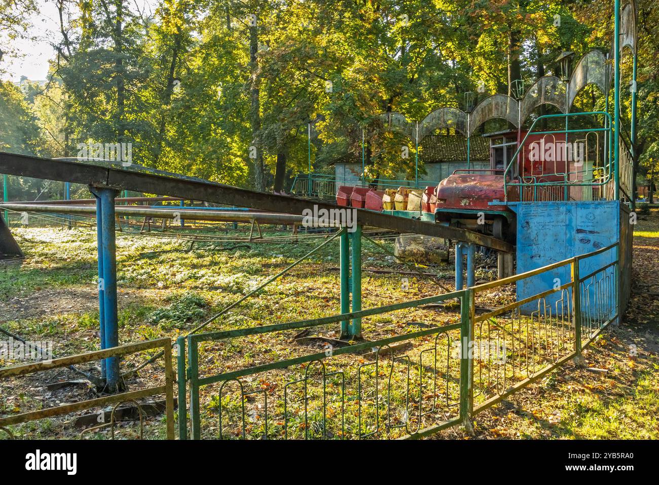 Rusty Park Rd An old, rusty, abandoned amusement park. A faded carnival ride is ...