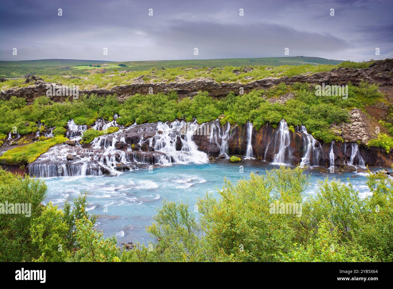 Hraunfossar - series of waterfalls formed by rivulets streaming over a ...