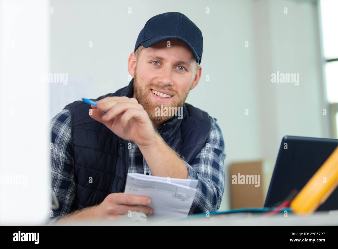 male technician checking reading of meter Stock Photo