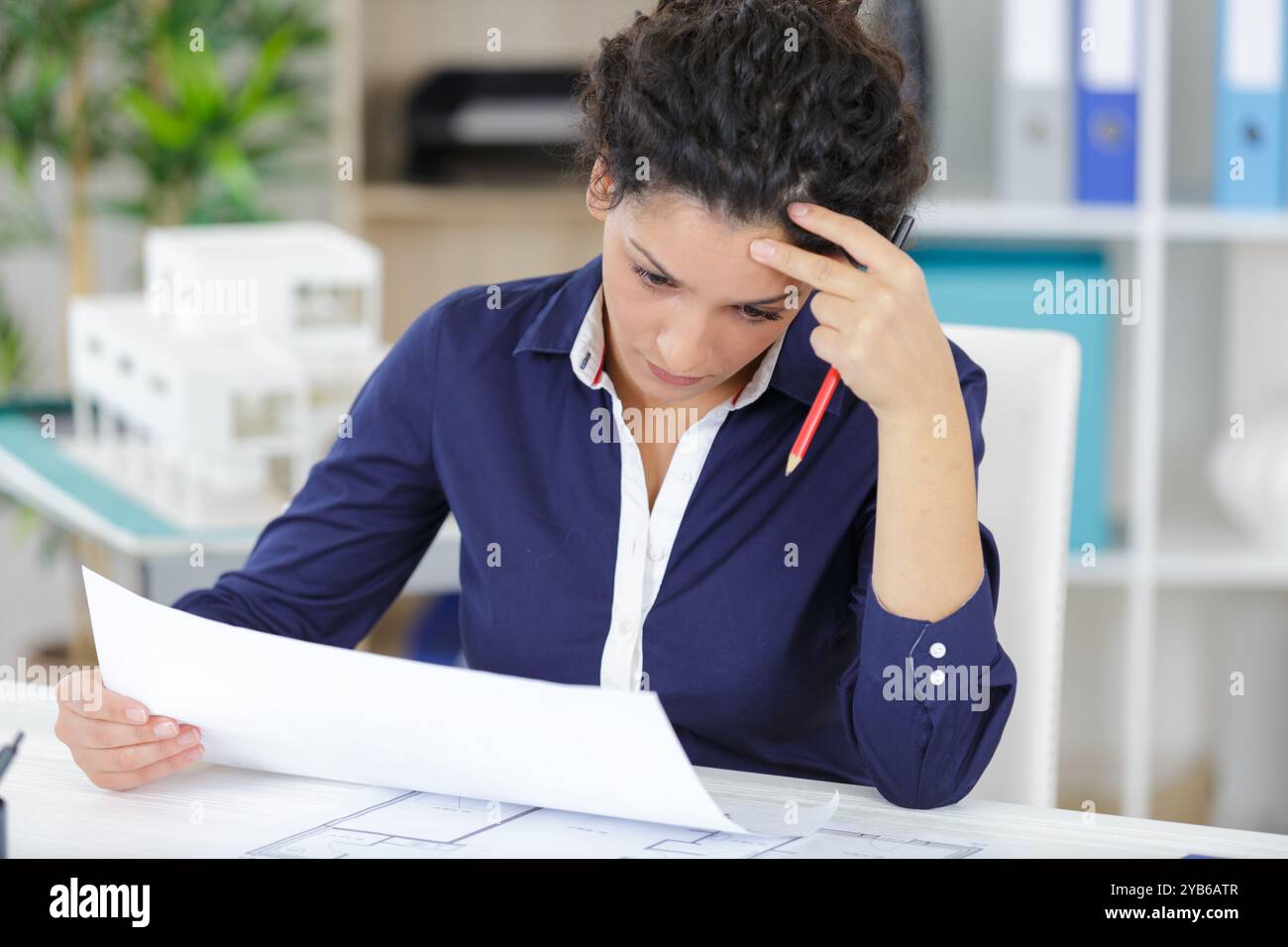 female construction engineer checking plans Stock Photo