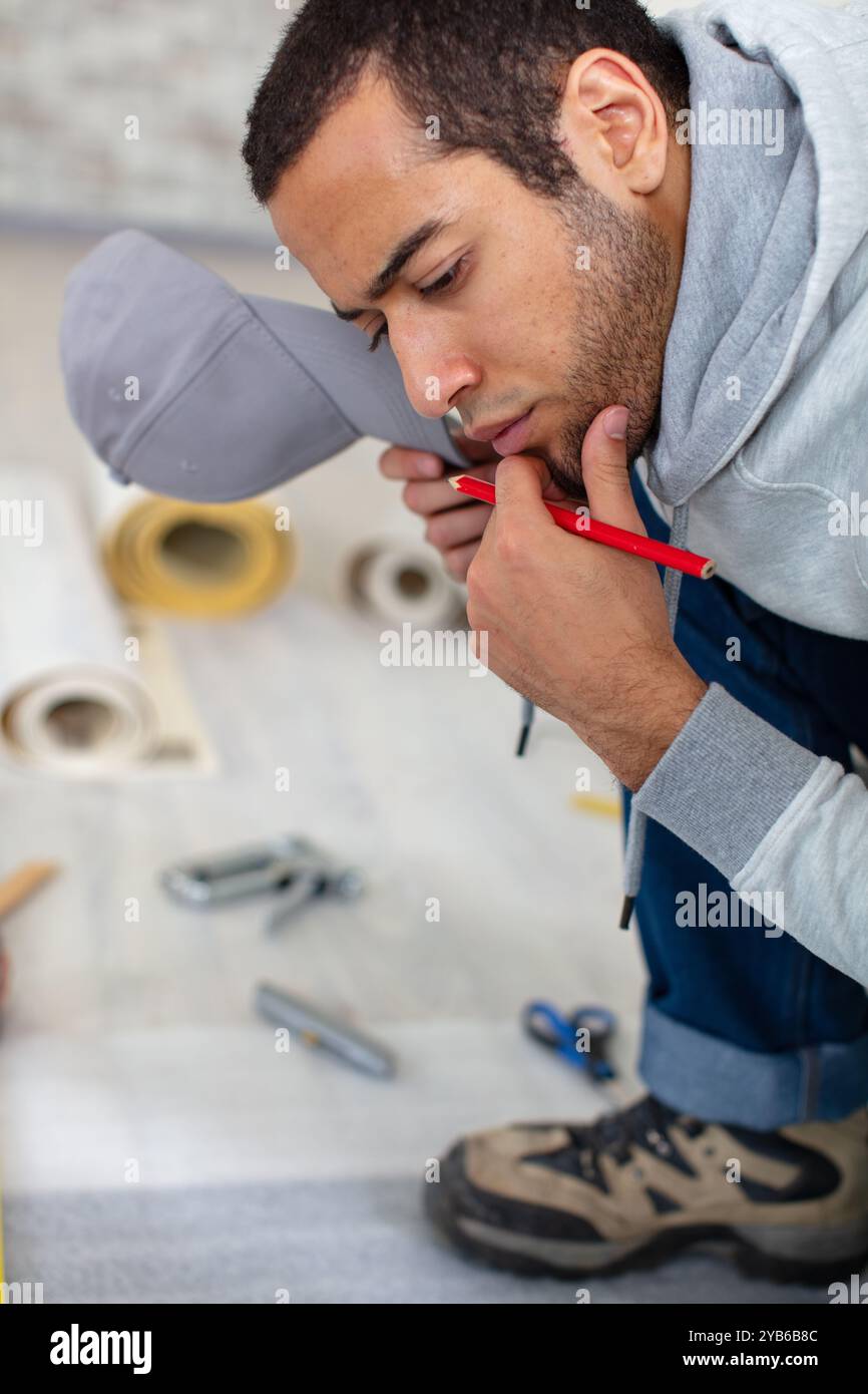 the builder thinking in work clothes Stock Photo