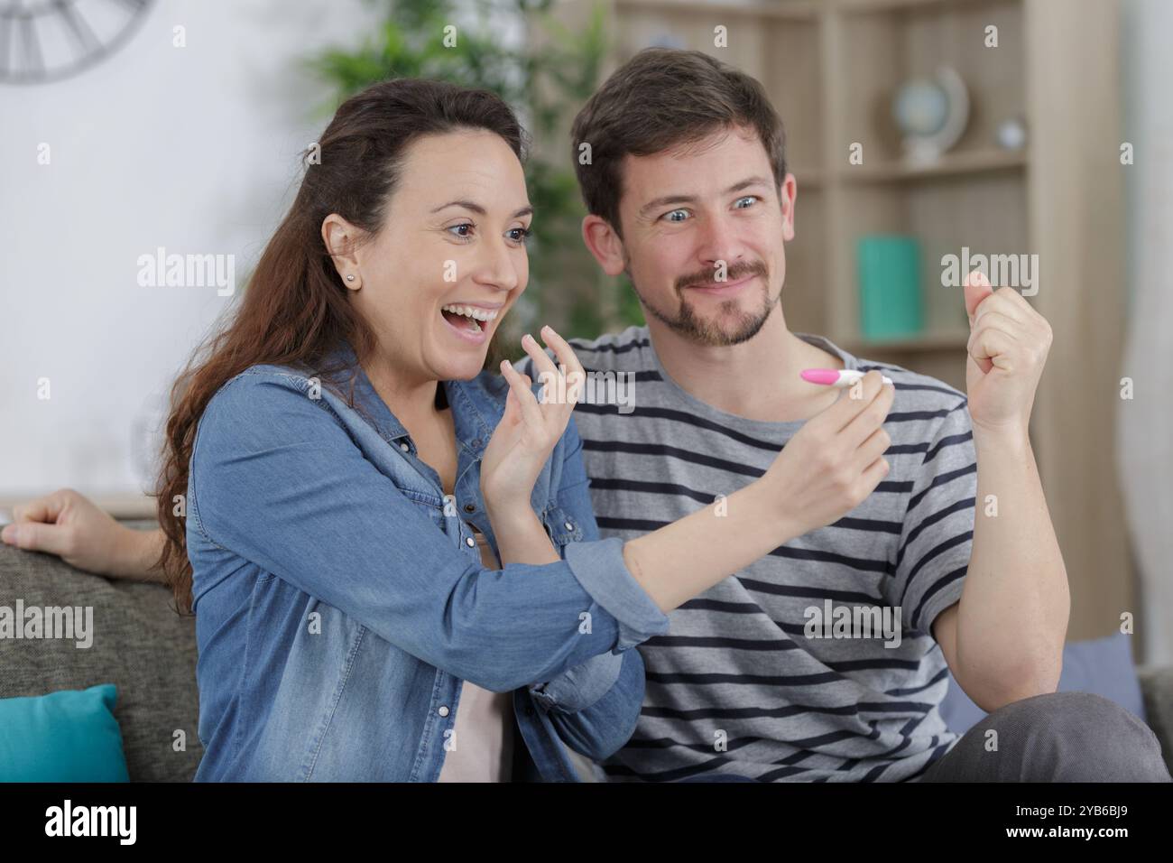 happy couple checking pregnancy test Stock Photo - Alamy