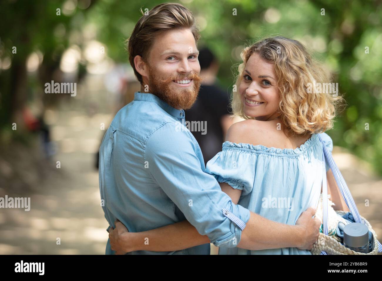 back view of young couple walking in park Stock Photo - Alamy