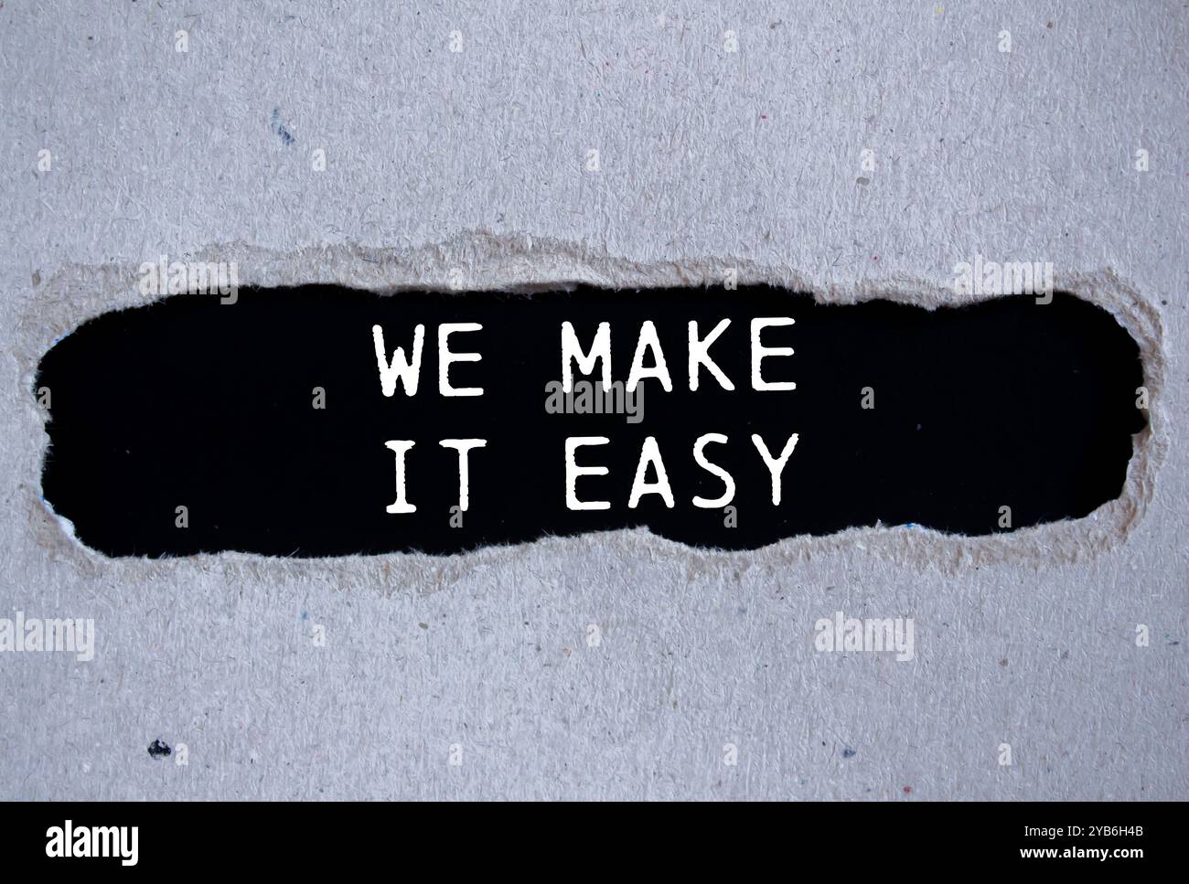 We make it easy message written on ripped torn gray paper with black ...