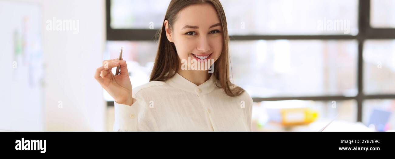 Young woman smiles holding investigation papers and pen Stock Photo