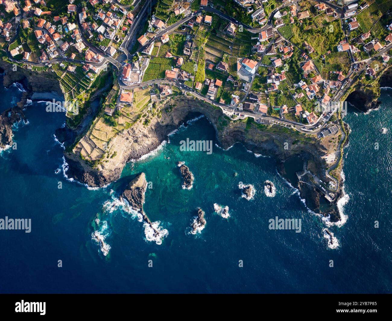 Aerial View of Coastal Village Overlooking Rocky Shoreline and ...