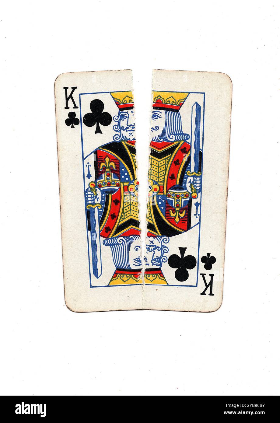 A vintage playing card torn in half from top to bottom on a white ...