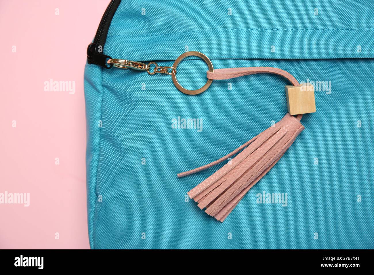 Backpack with leather keychain on pink background, top view Stock Photo