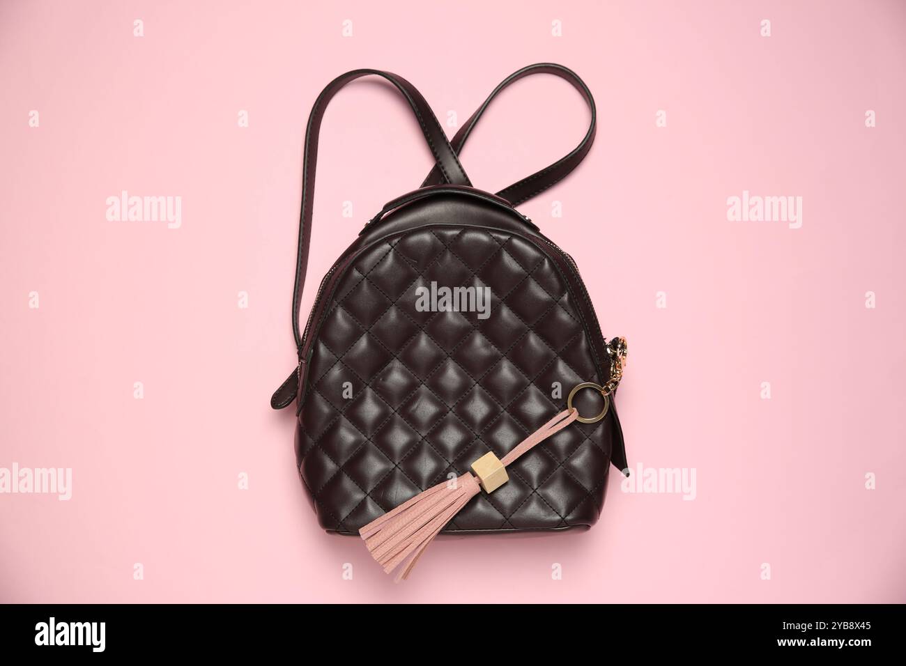 Backpack with leather keychain on pink background, top view Stock Photo