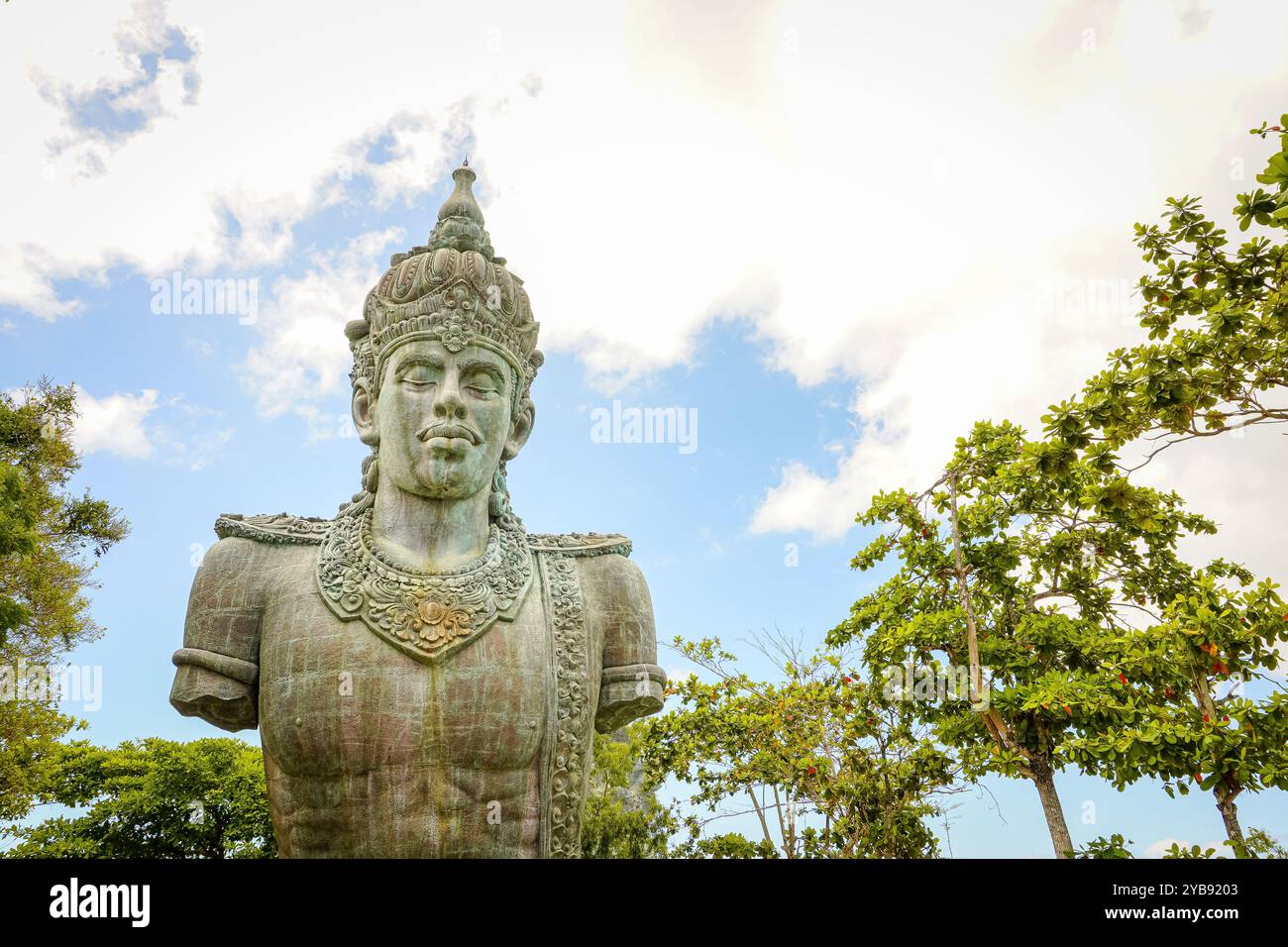 The statue of Lord Vishnu against the backdrop of a cloudy blue sky at the Garuda Wisnu Kencana Cultural Park in Bali, Indonesia. Copy space image Stock Photo