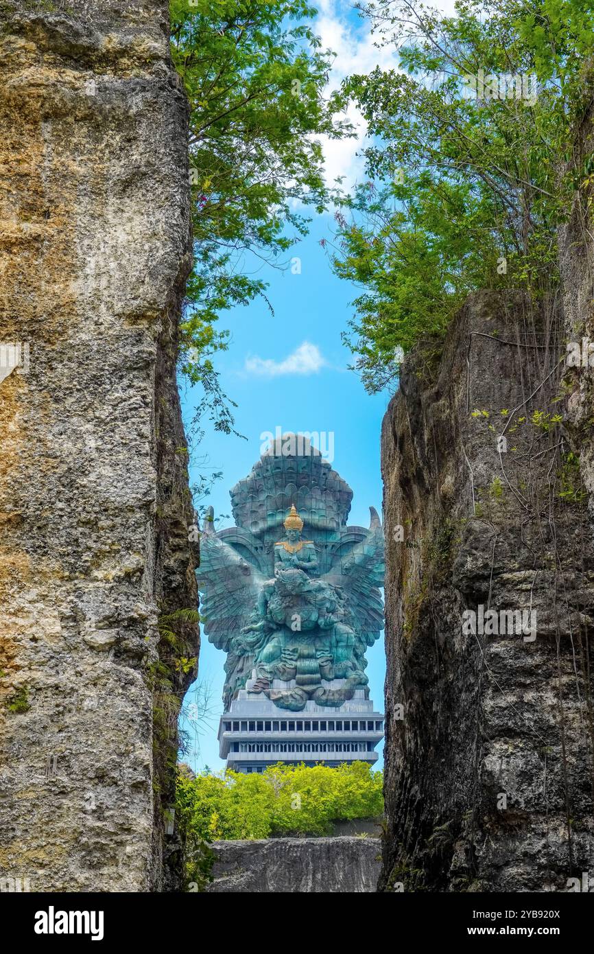 Portrait of the statue of Lord Vishnu against the background of a cloudy blue sky at the Garuda Wisnu Kencana Cultural Park Bali, Indonesia Stock Photo