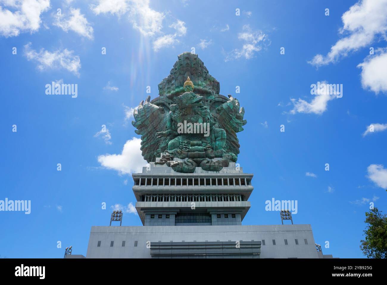 The statue of Lord Wishnu against the backdrop of a cloudy blue sky at the Garuda Wisnu Kencana Cultural Park in Bali, Indonesia. Copy space image Stock Photo