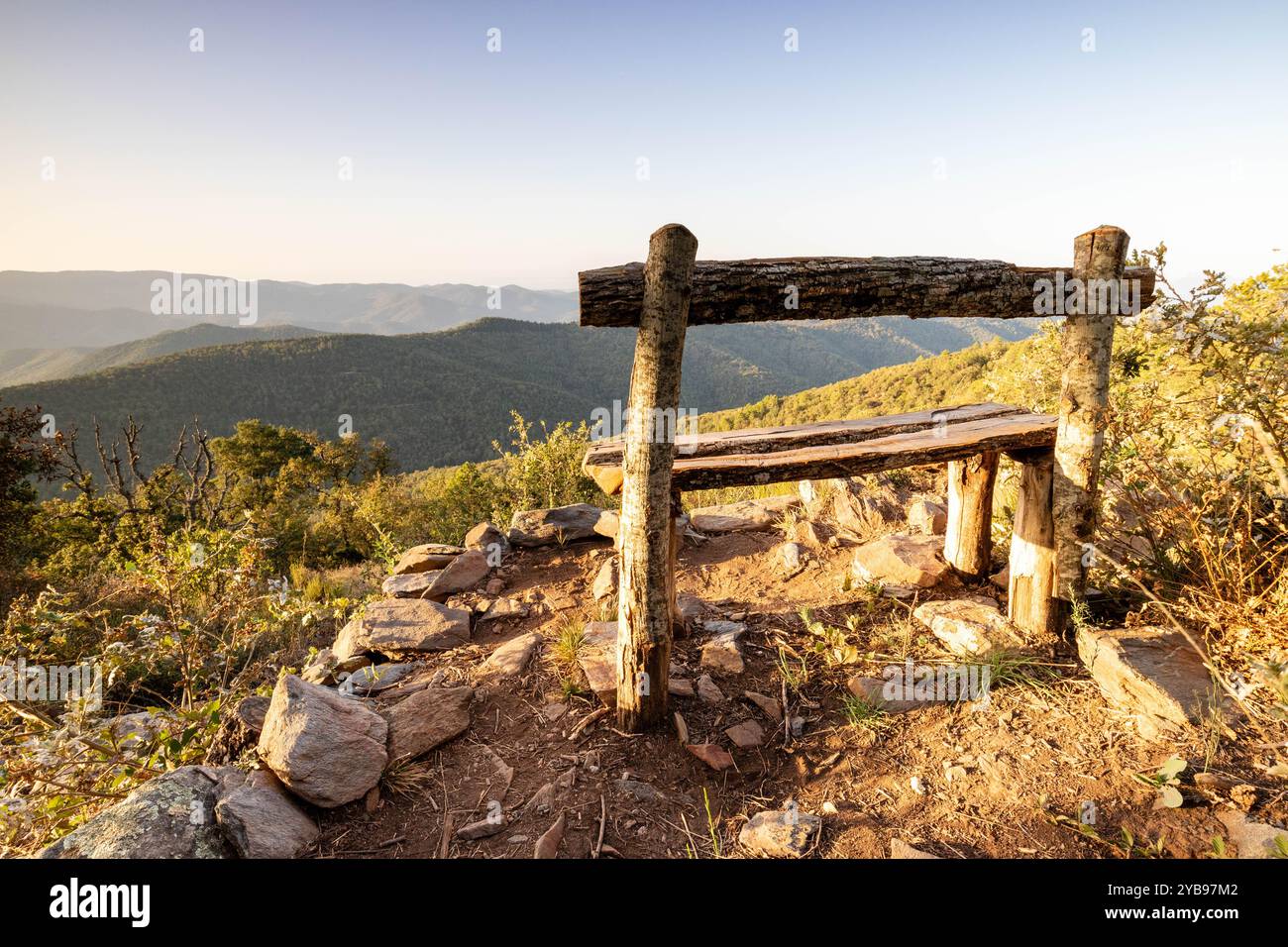 Wooden bushcraft publc bench on the way on Notre Dame des Anges with view on Massif des Maures, in France, Europe, Provence. Stock Photo