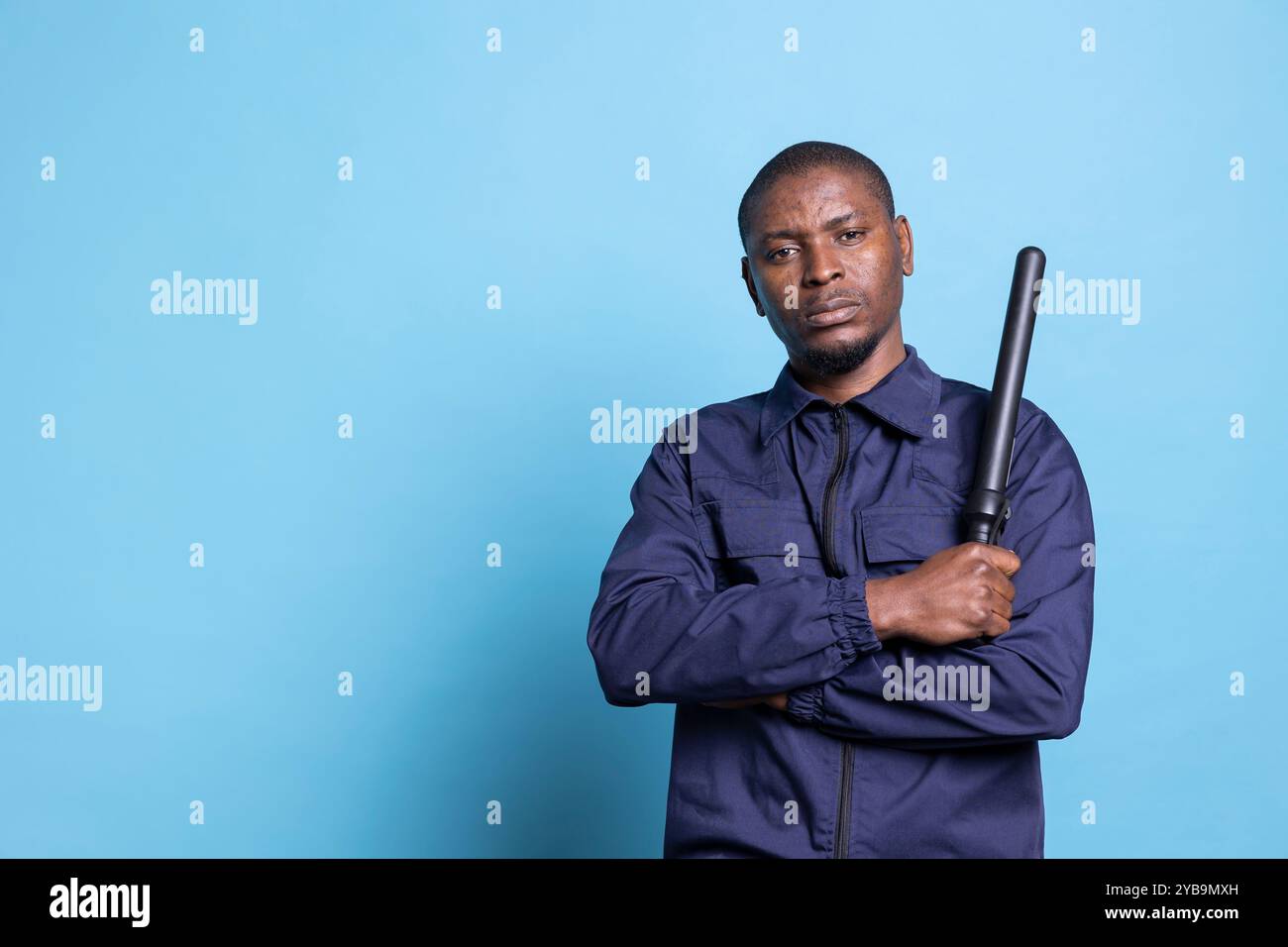 African american security guard feels proud with his baton in studio ...