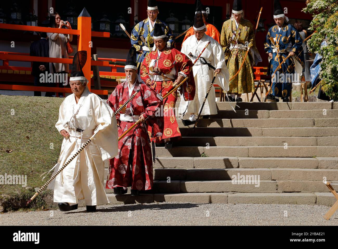Male archers in traditional ceremonial robe and head piece entering the ...
