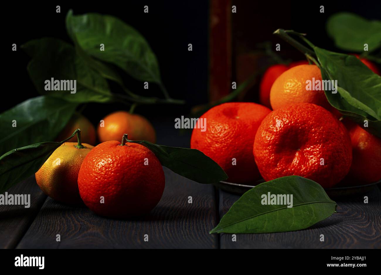 Fresh tangerines with leaves, close-up, on a wooden table, horizontal, no people Stock Photo