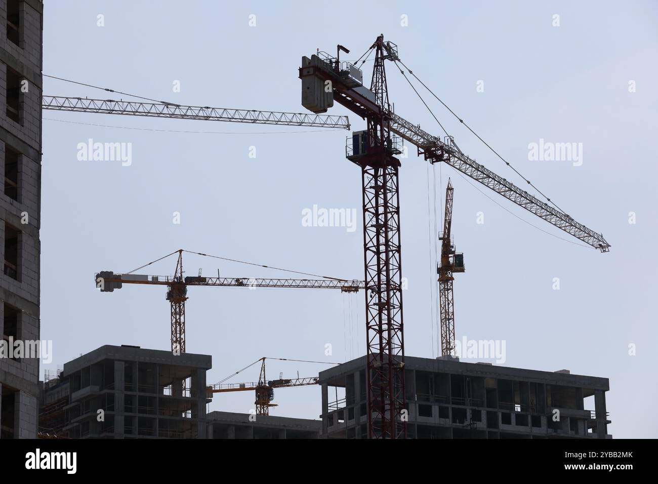 Construction cranes move building materials hi-res stock photography ...