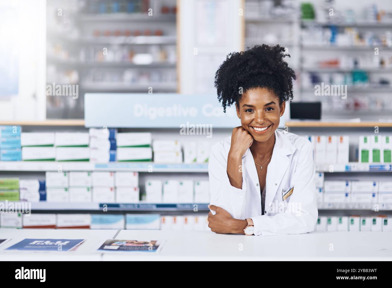 Pharmacy, doctor and woman in portrait by counter, medical advice and drugstore for customer service. African female person, pharmacist and confidence Stock Photo