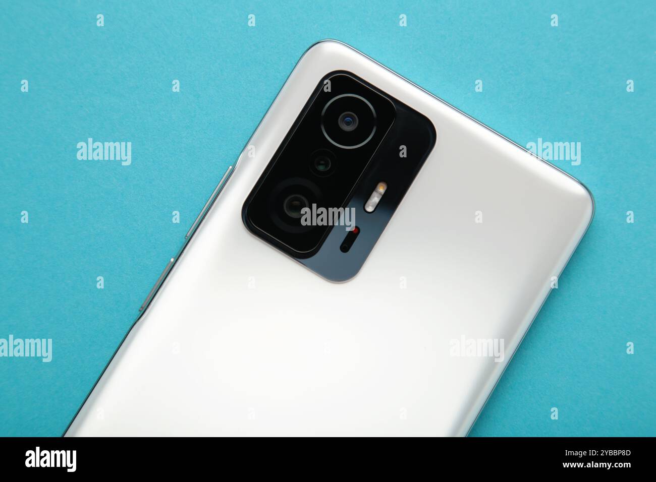 Mobile phone camera, flash lens on blue background. Top view Stock Photo